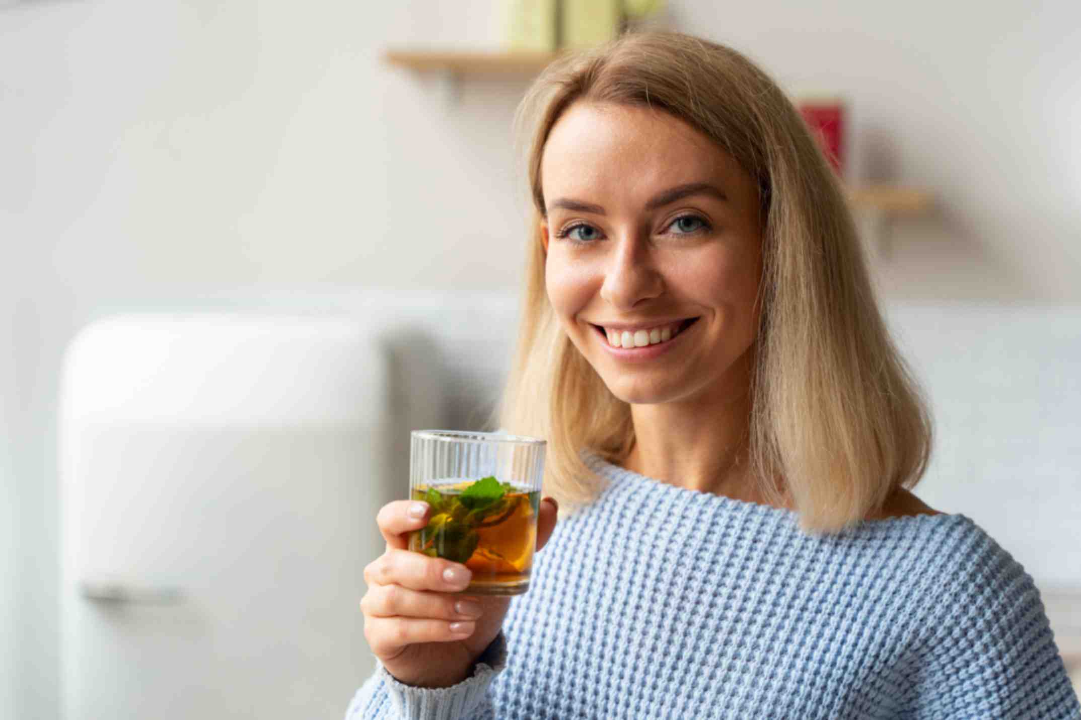 beautiful woman holding a cup of green tea.