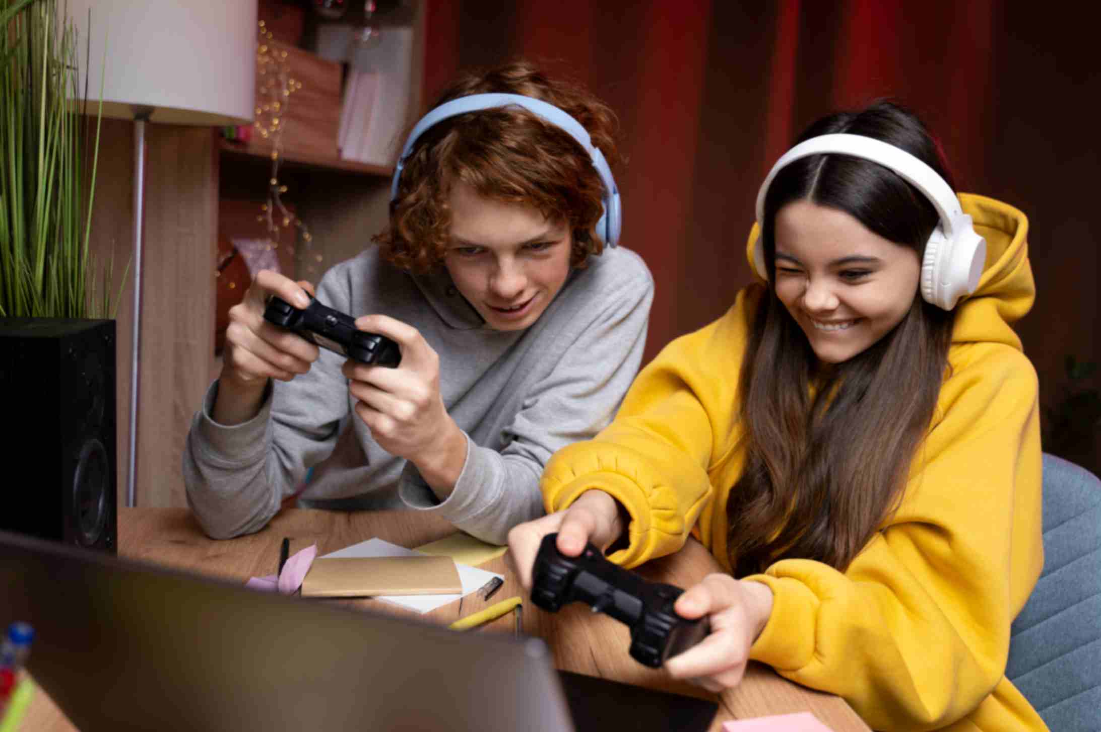 Teenage friends playing video games together at home